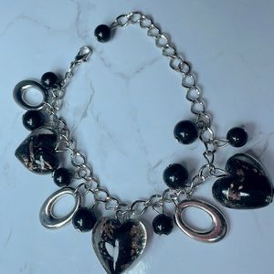 Charm bracelet with black and gold glass heart charms and black beads